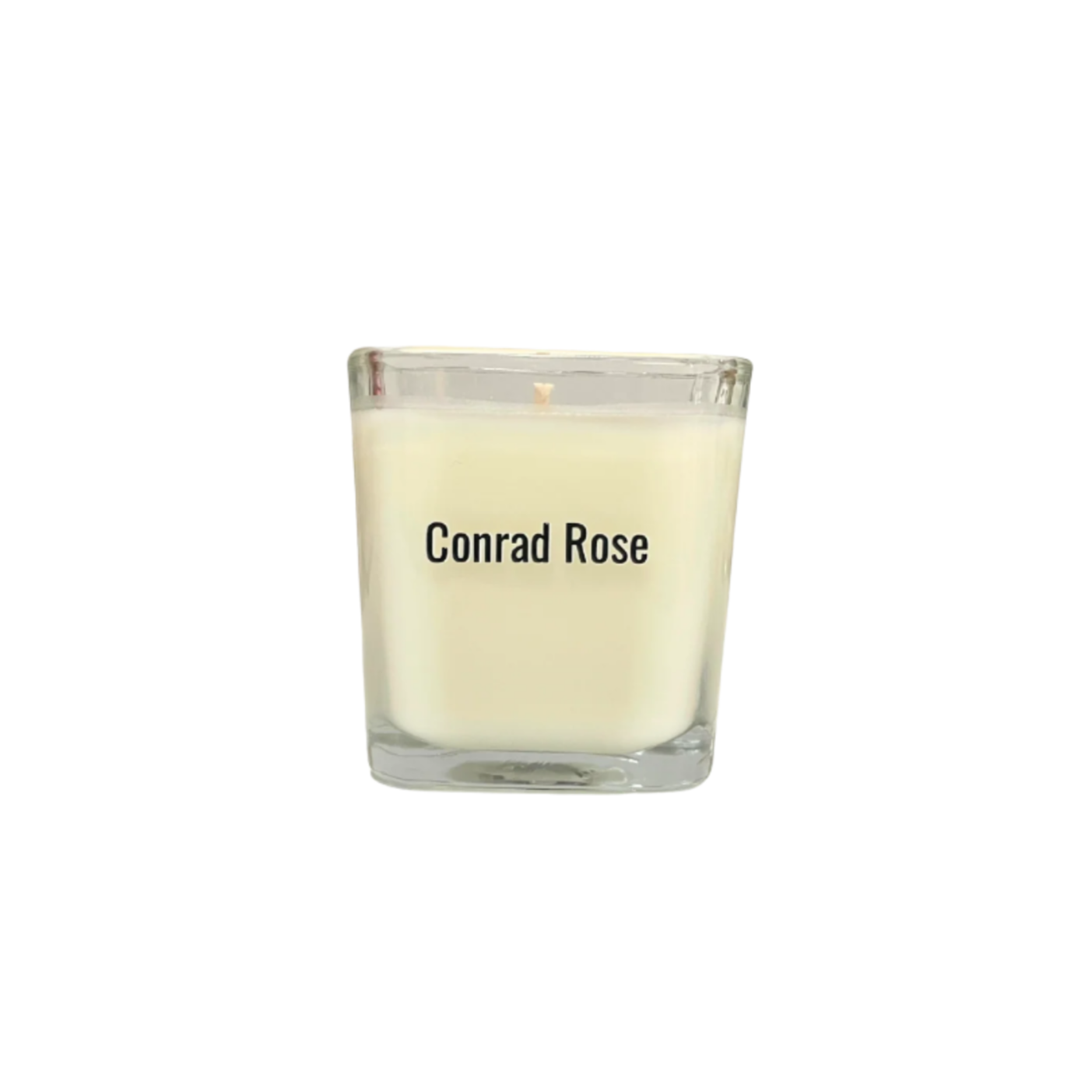 Glass candle with 'Conrad Rose' branding on a white background